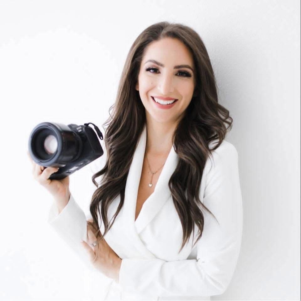 Amanda Capello smiling and holding a camera